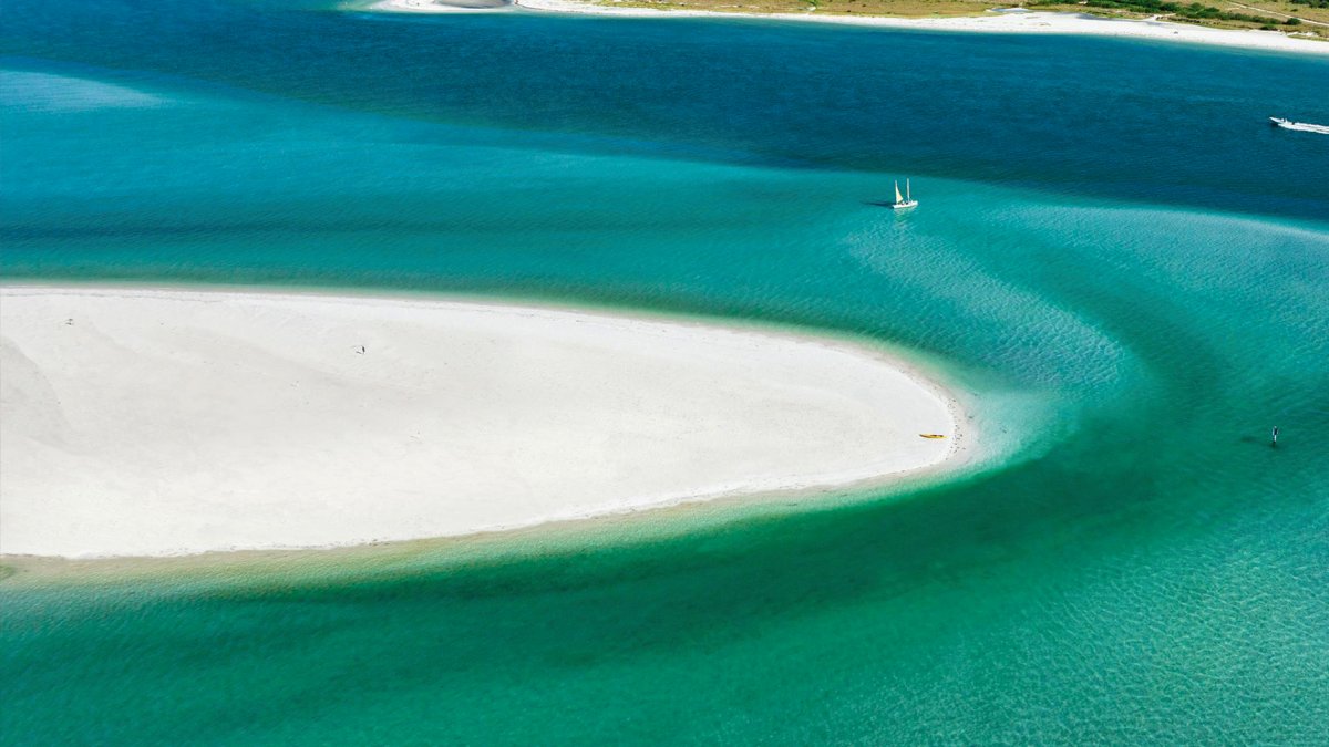 An aerial photo of Caladesi Island, an uninhabited island with a white-sand beach.