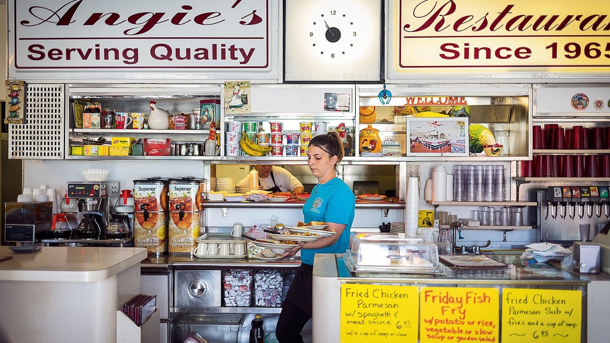 A server brings out food at Angie's Restaurant in Clearwater