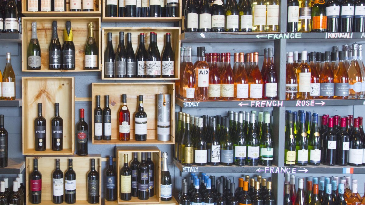 A wall filled with wine bottles, floor to ceiling