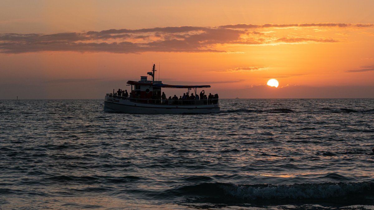 The Little Toot Dolphin Adventure boat at Sunset