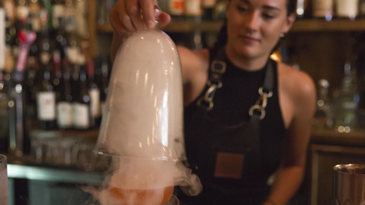 A bartender serves a Smokey cocktail at Mandrin Hide on Central Ave in downtown St. Pete