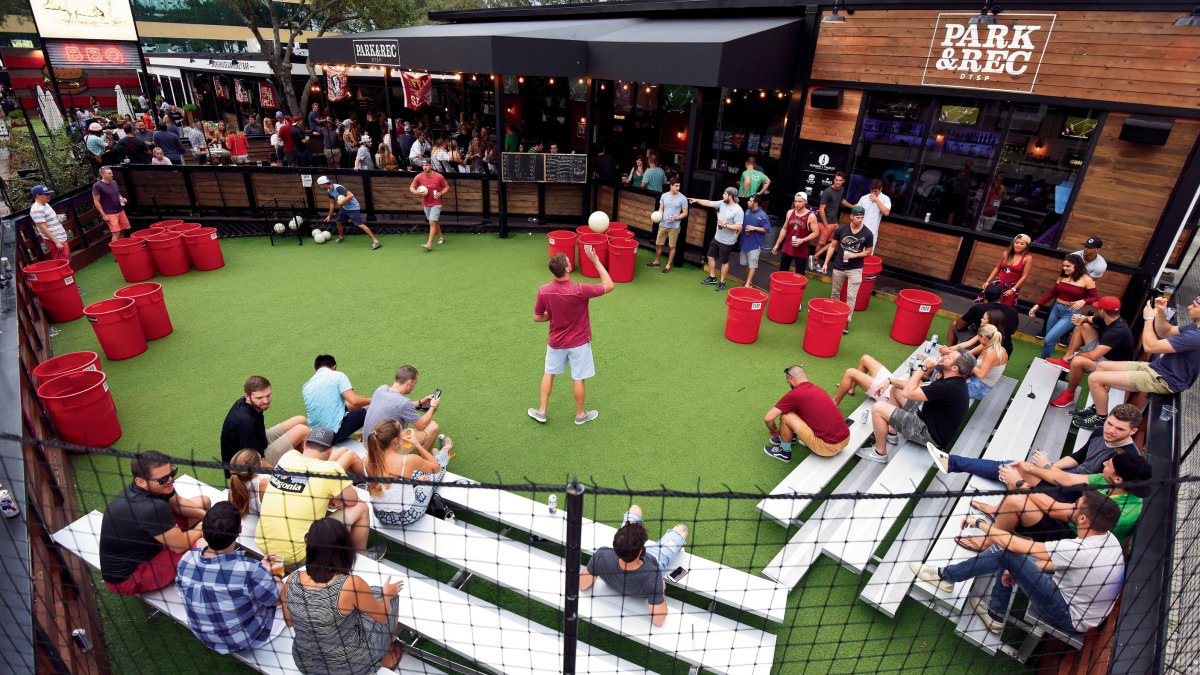 A group of people gathers to play bar games outside Parks & Rec in downtown St. Pete