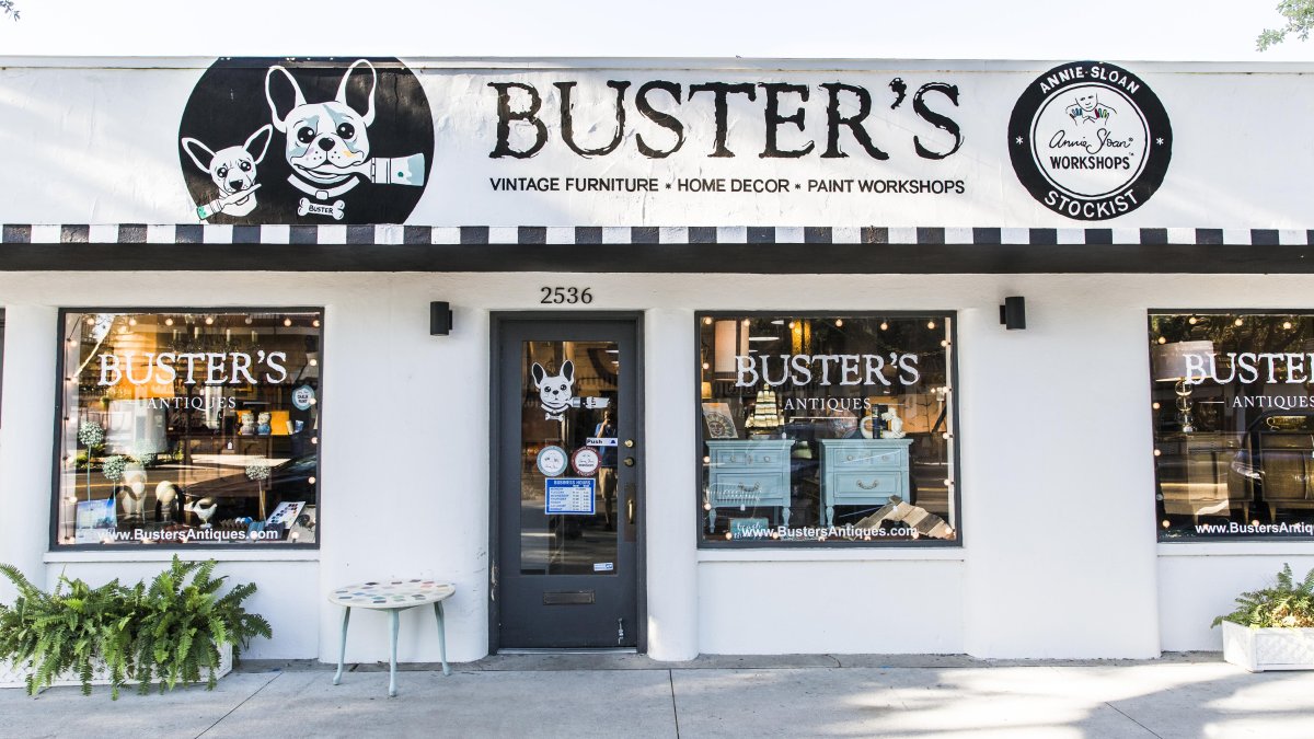 The Buster's Antique shop storefront painted all in black and white.