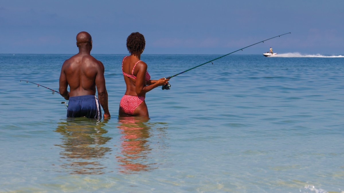 An African-American couple fishing in the Gulf in St. Pete Beach.