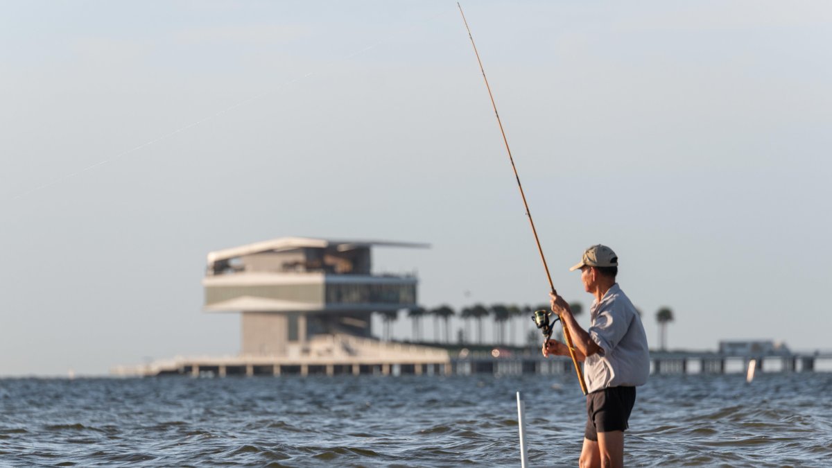 A man fishing at North Shore Park near the St. Pete Pier.