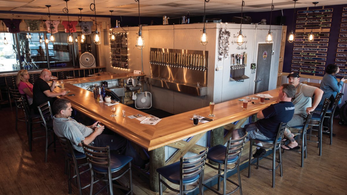 The interior view of Stilt House Brewery showing few people drinking.