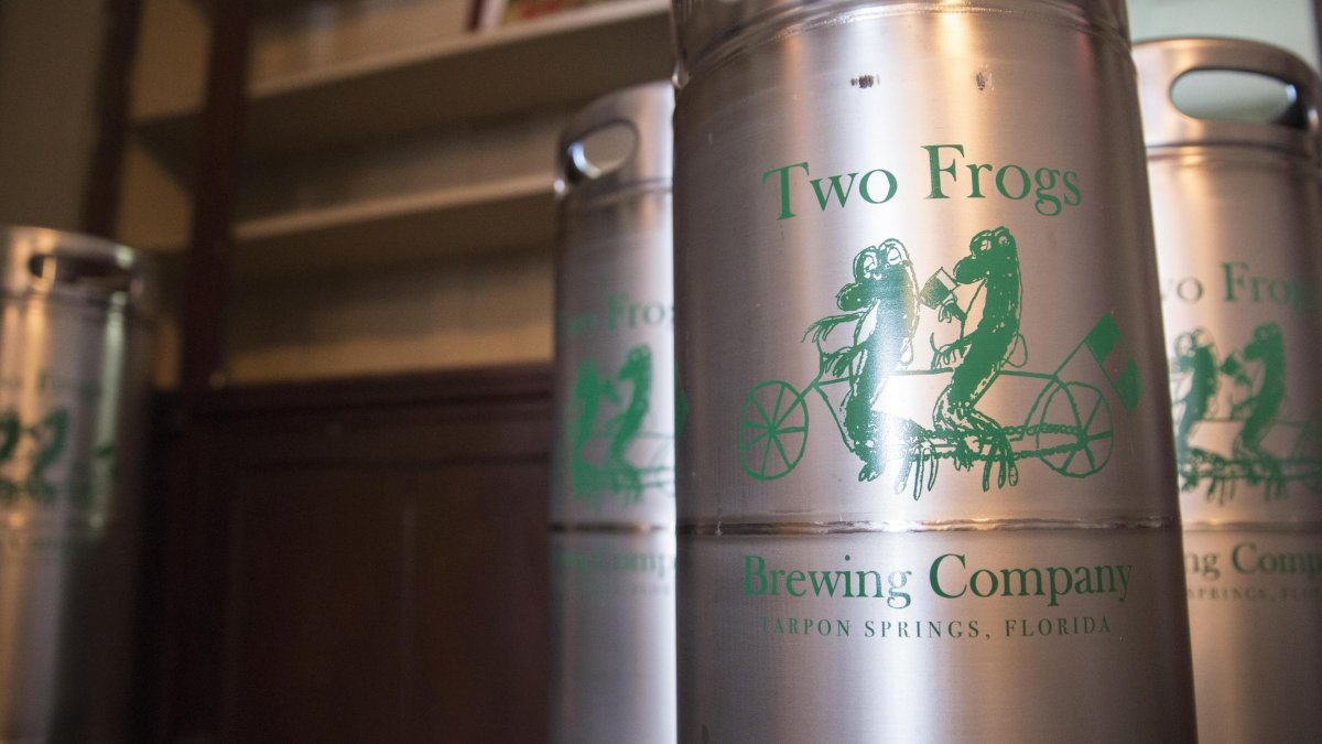 Metal beer containers showing a logo with two frogs