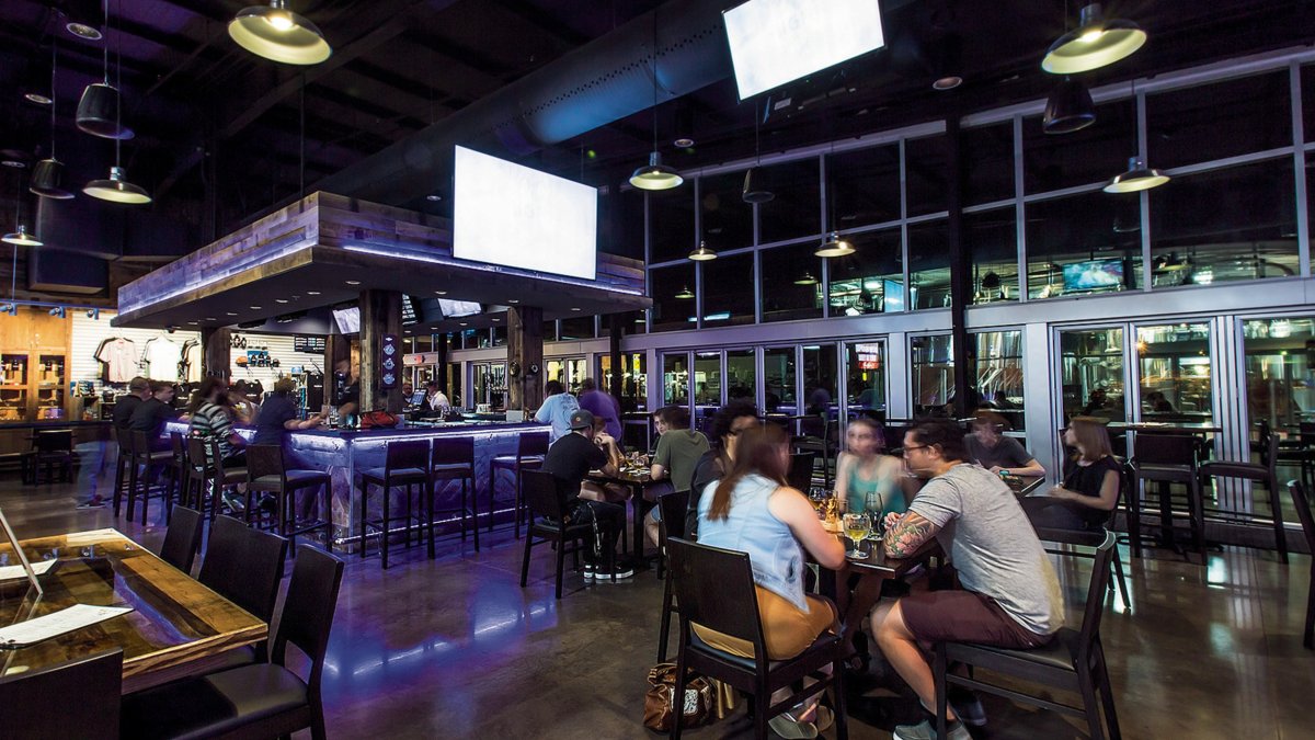 Couple of people dining near the blue lights around the bar at Big Storm Brewing Co.