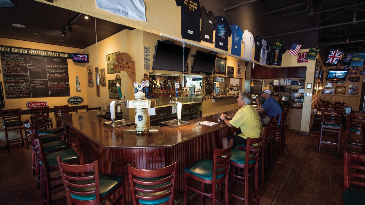 The interior view of Lagerhaus Brewery showing two people drinking at the bar.