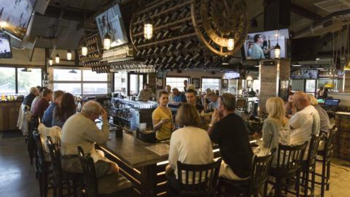 Several people around the bar at Sea Dog Brew Pub.