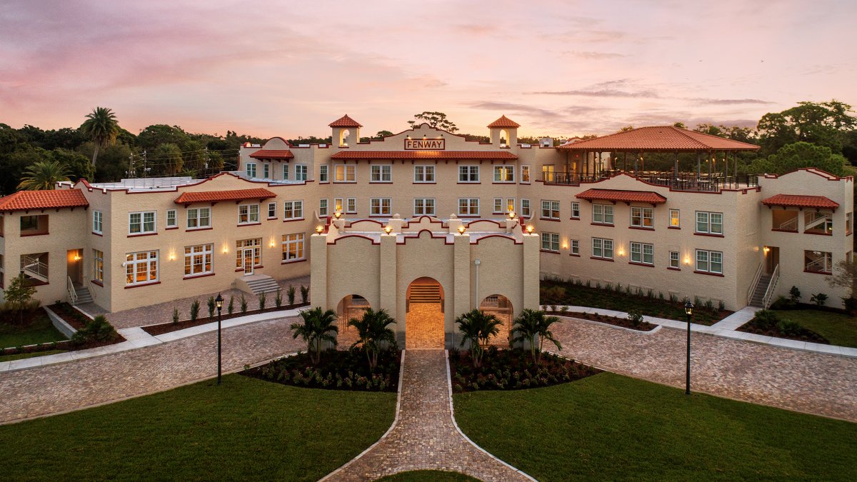 An aerial view of a large hotel at sunrise