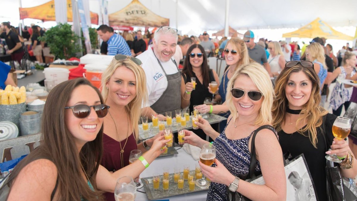 A group of people sampling food at Savor St. Pete