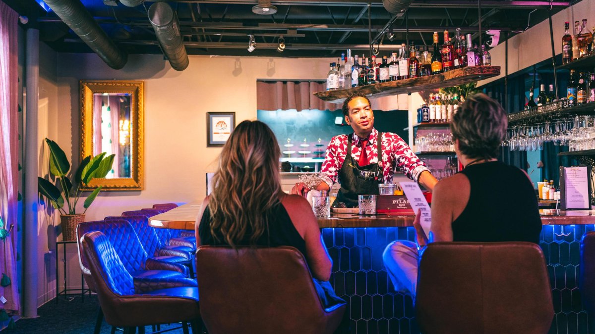 Two women enjoying cocktails at The Nest bar in Dunedin.