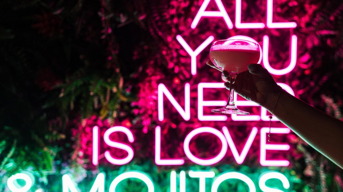 All you need is love and mojitos neon sign at Dirty Laundry restaurant in St. Pete