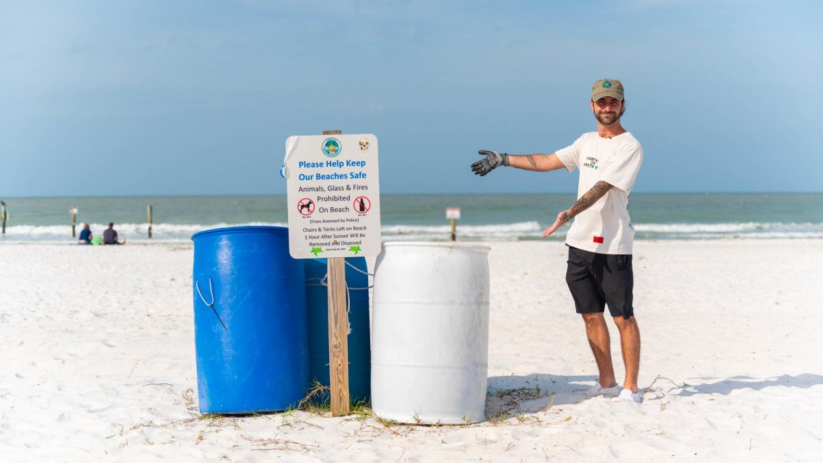 Caulin Donaldson, aka TrashCaulin, points to trash cans