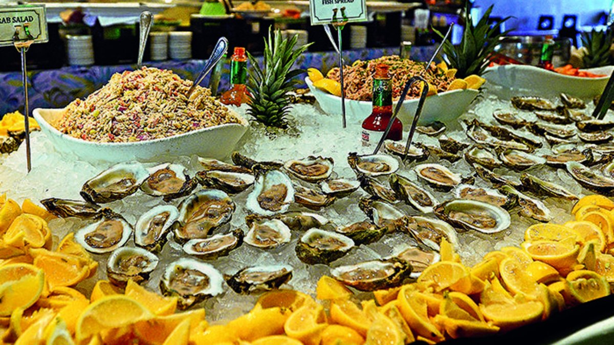 oysters and shrimp are surrounded by cut lemons on a brunch table at Island Way Grill in Clearwater