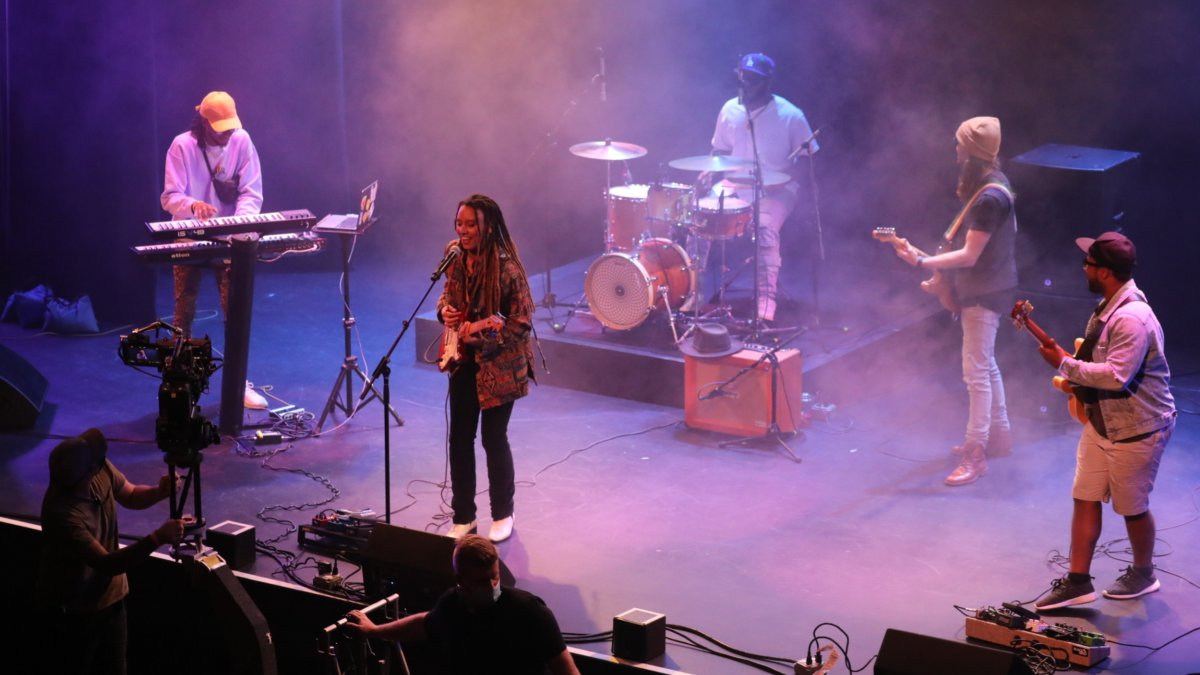 Photo of five musicians playing on stage at the Bilheimer Capitol Theatre in Clearwater. Photo features include purple lighting and stage fog. 