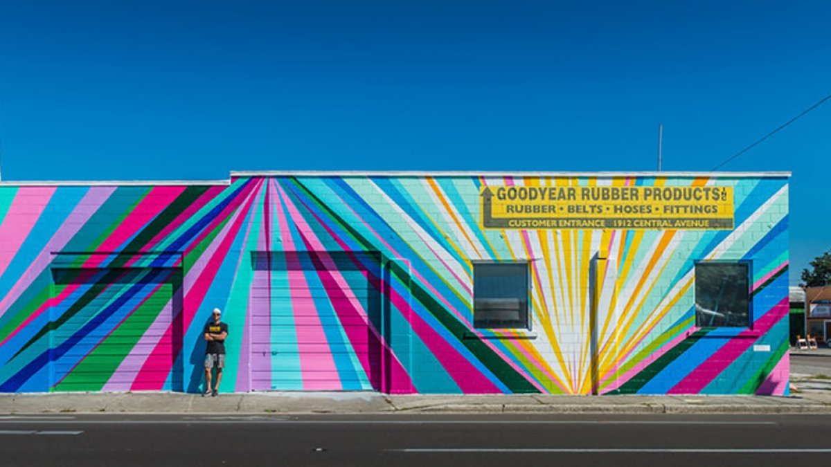 mural with colorful rays pointing upward