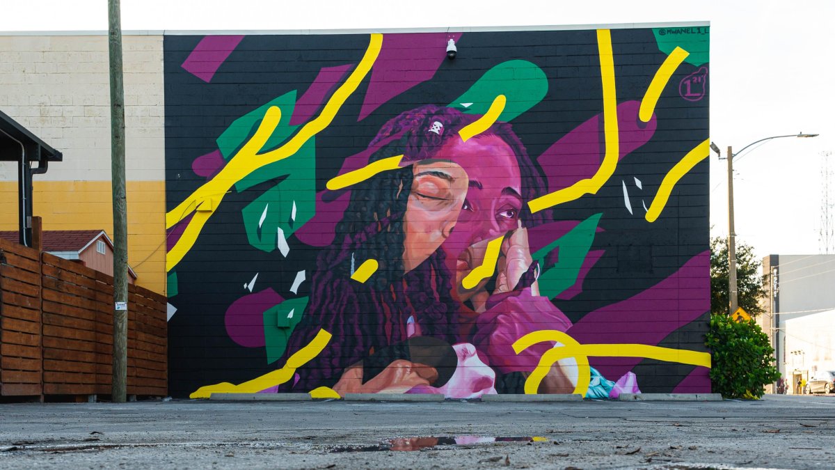 a colorful mural of showing faces of several black people with yellow green purple and black graphic background by Mwanel Pierre-Louis