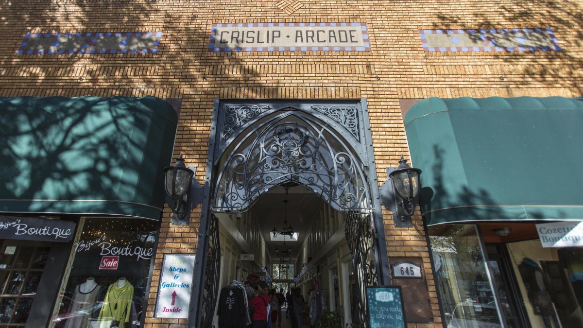 Outside shot of the Crislip Arcade featuring brown brick walls and green building shades.