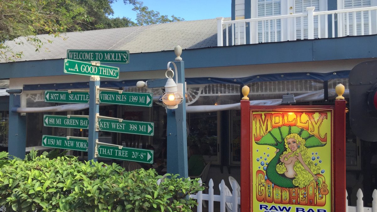 a sign of a mermaid outside Molly Goodheads restaurant in Ozona