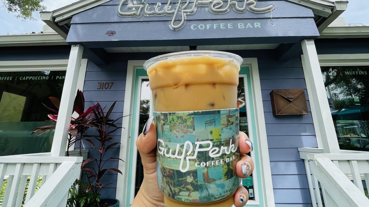 cup of iced coffee in front of GulfPerk Coffee Bar entrance