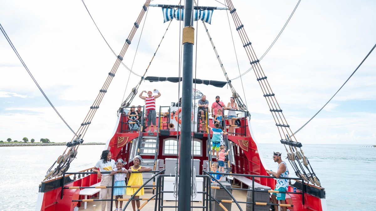 Families on the deck of the bright red Captain Memo Pirate Cruise in Clearwater Beach