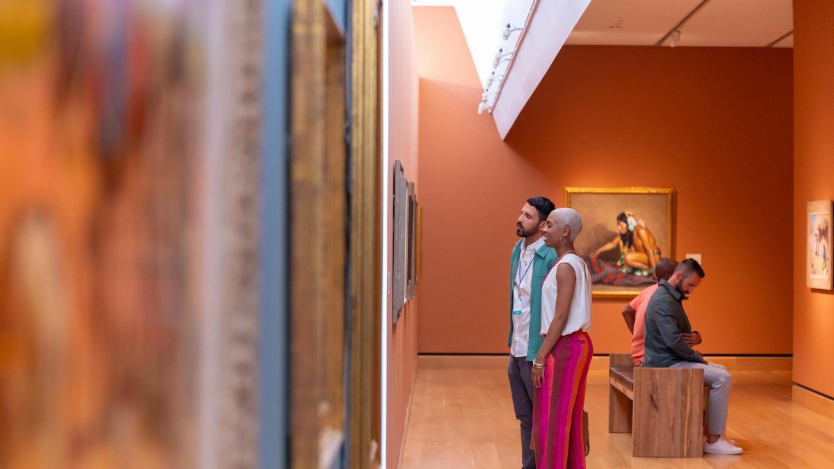 A couple looks at paintings in the James Museum