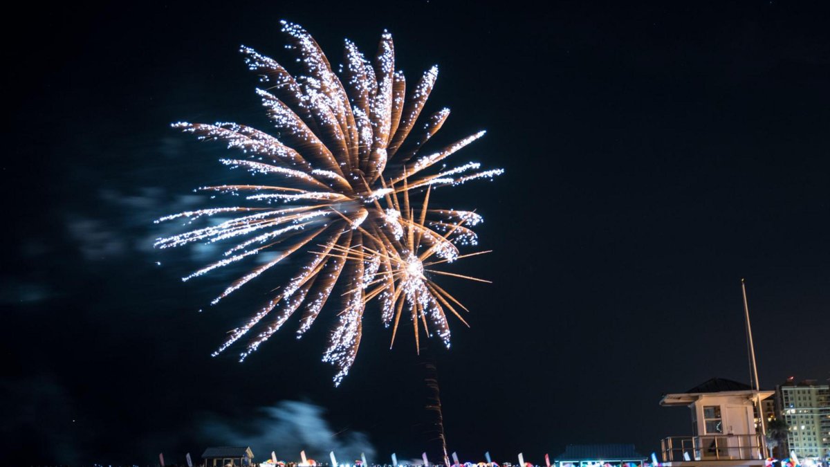 Fireworks explode over the water off Clearwater Beach.