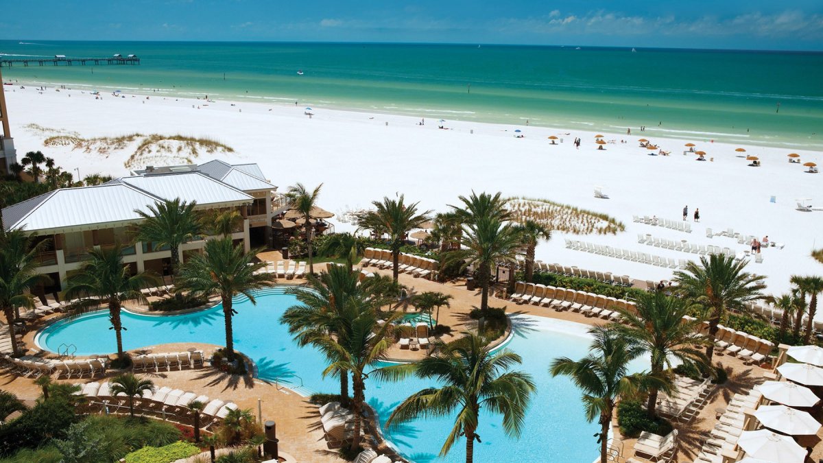 Sandpearl pool with palm trees and beach