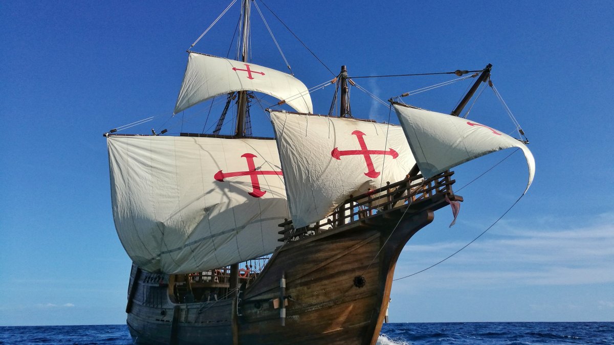 A tall ship with billowing white sails