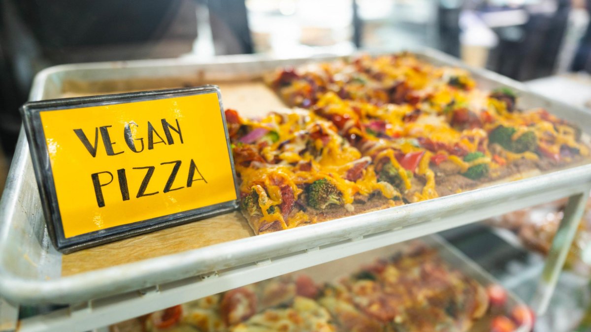 Vegan pizza with a sign saying vegan pizza