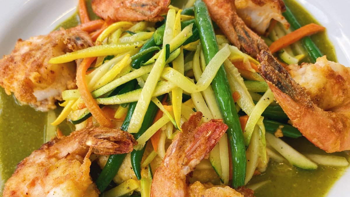 Shrimp and green and yellow veggies on a white plate