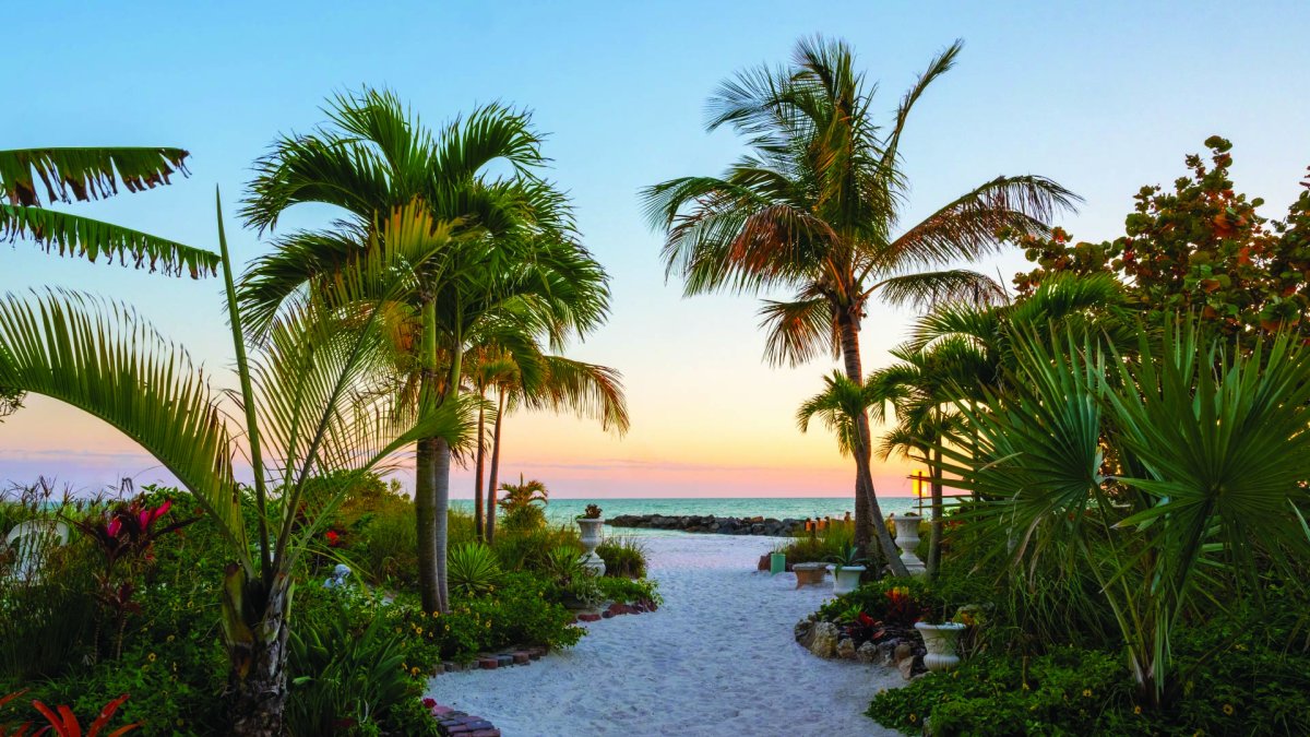 a pathway to the beach during sunset