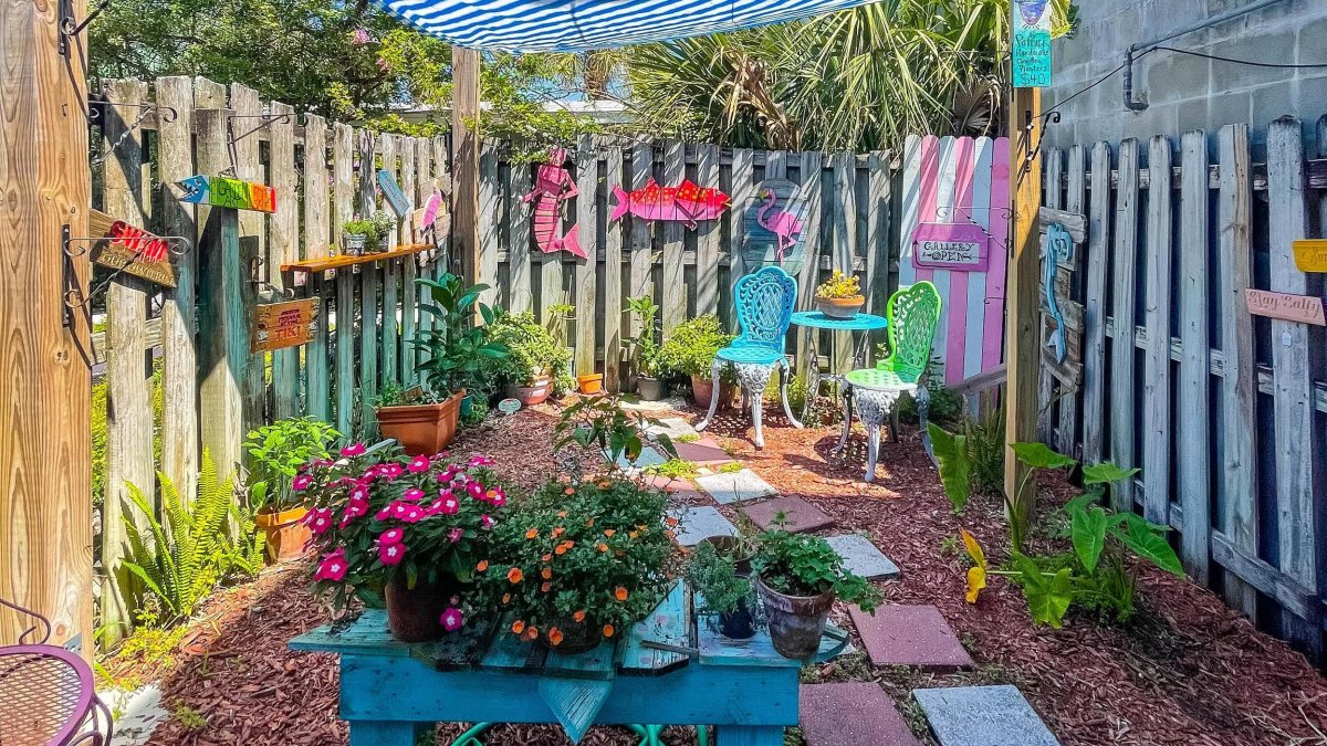 A whimsical courtyard filled with colorful crafts and signs.