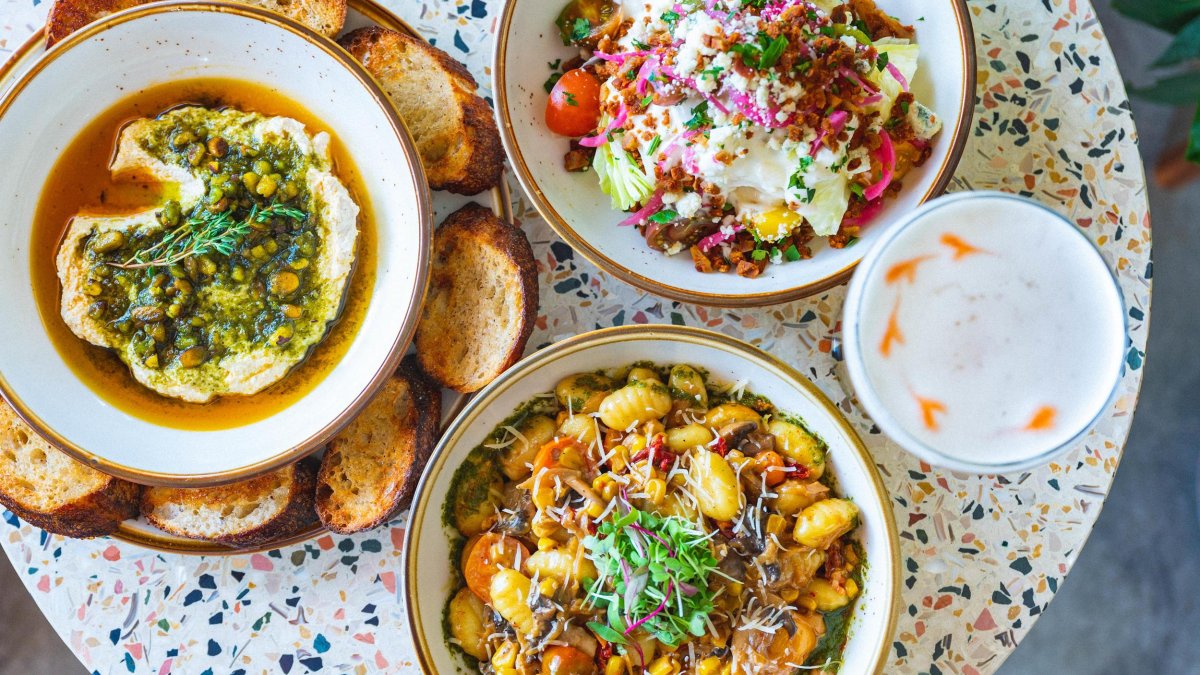 Three dishes of vegan food on a speckled table