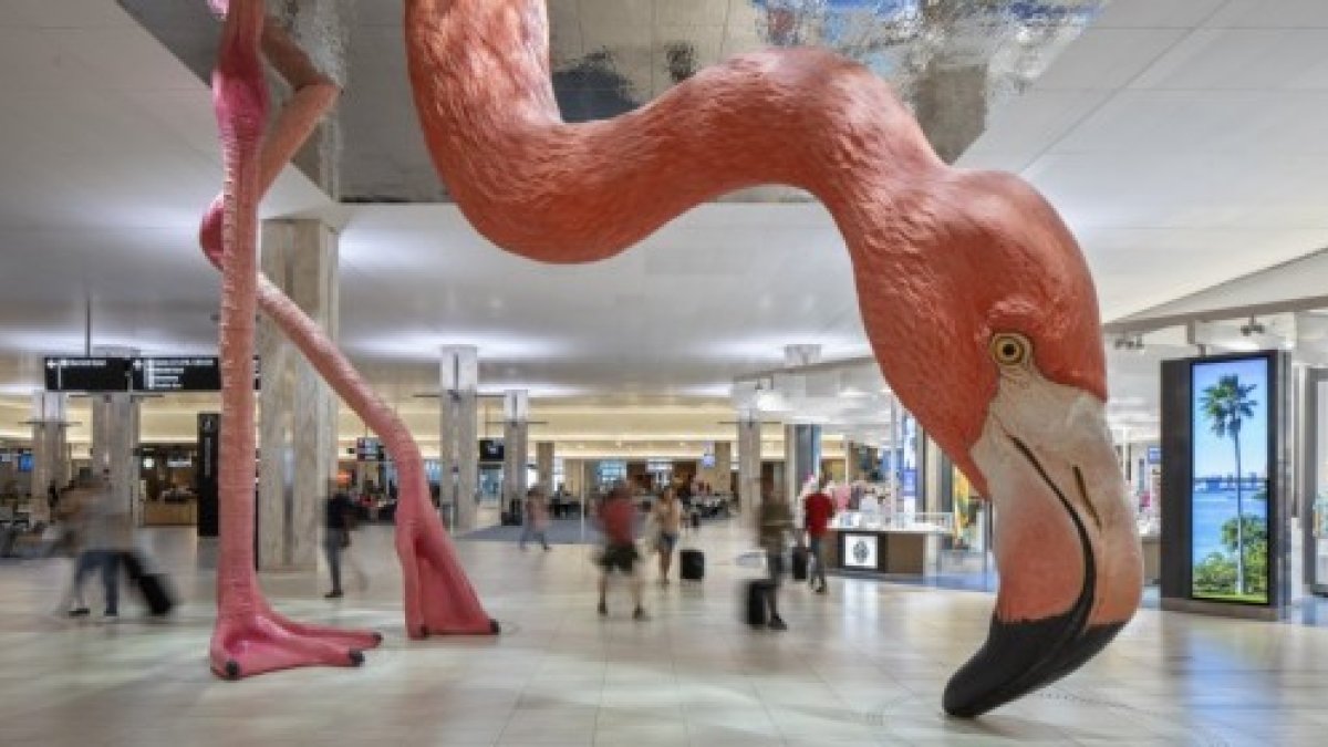 an enormous pink flamingo sculpture with beak to the floor at Tampa International Airport