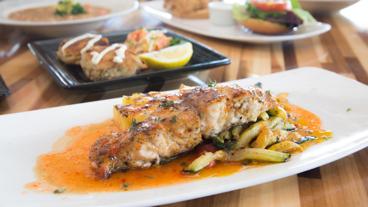 Grouper on a dish with sauce and veggies