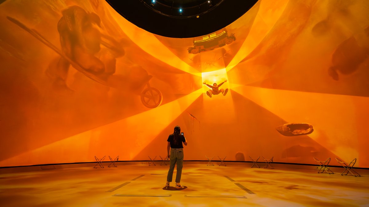 Dome projection with woman in front of it 