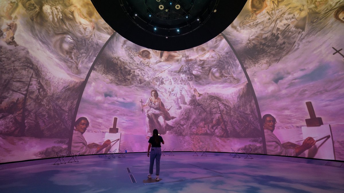 Dome projection with woman in front of it