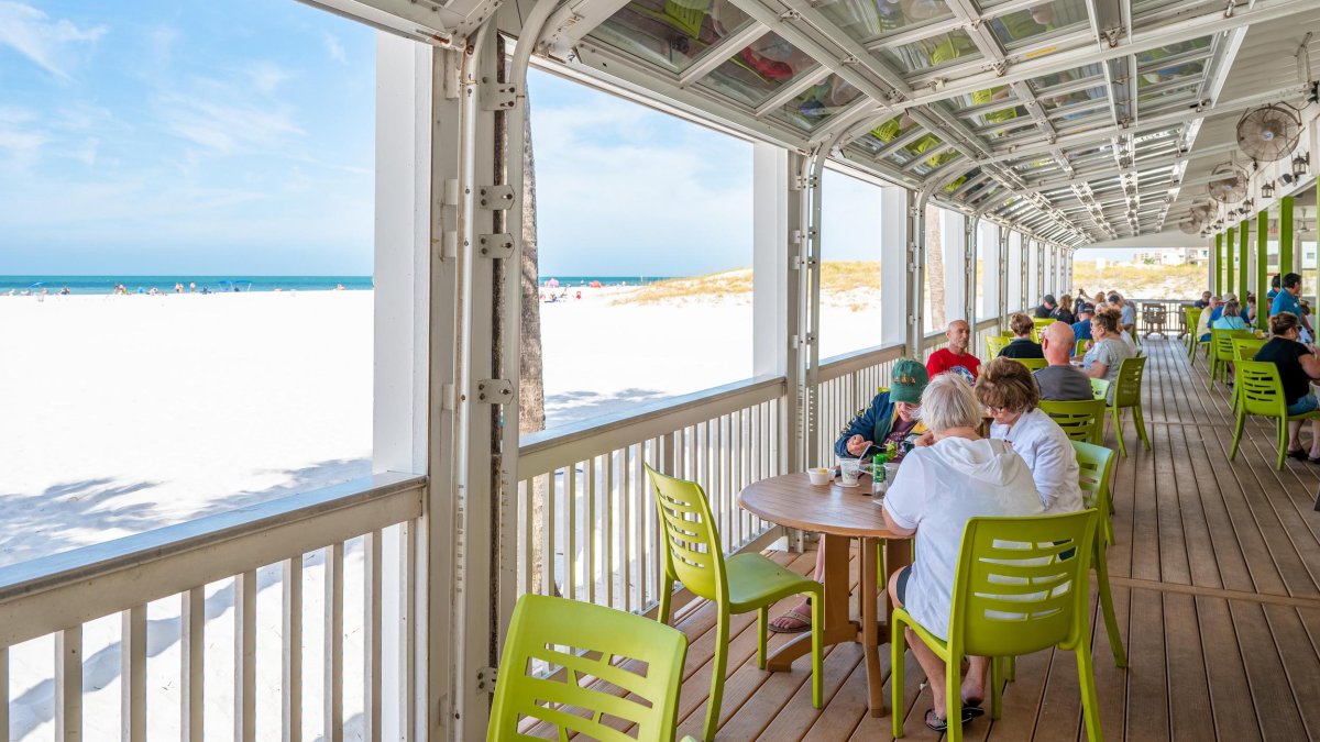 People dine at a restaurant overlooking Clearwater Beach