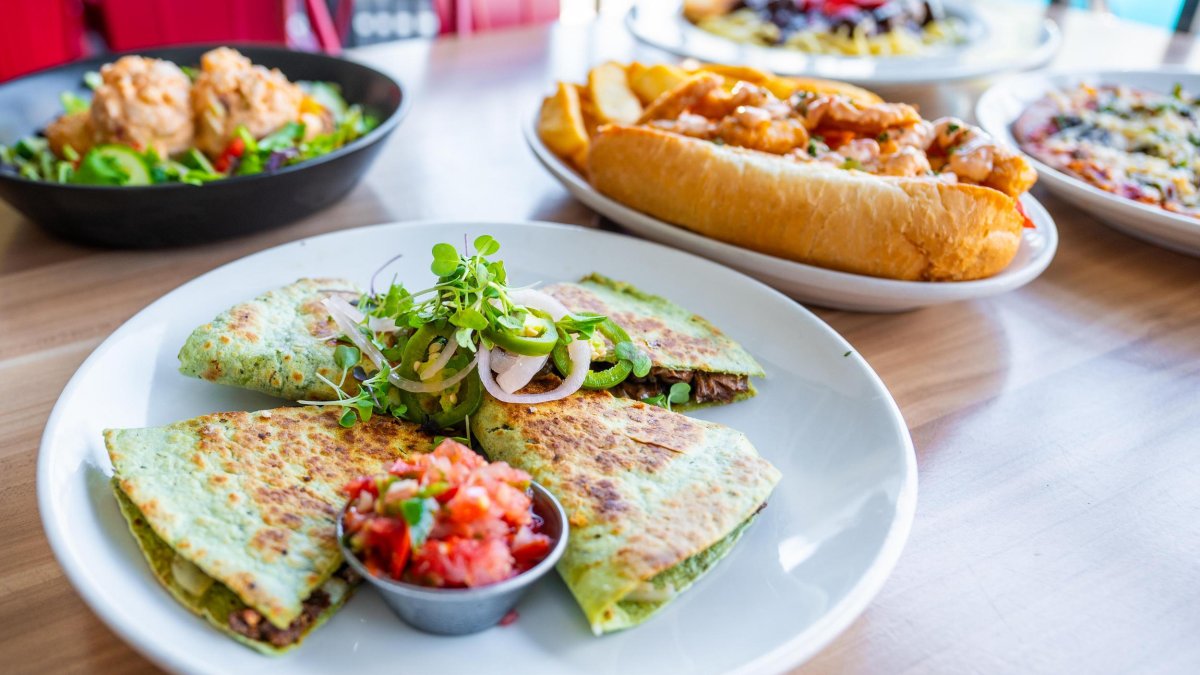 Vegan sandwich on pita on a table with other dishes
