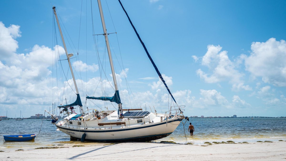 a sailboat on Gulfport Beach after Hurricane Idalia