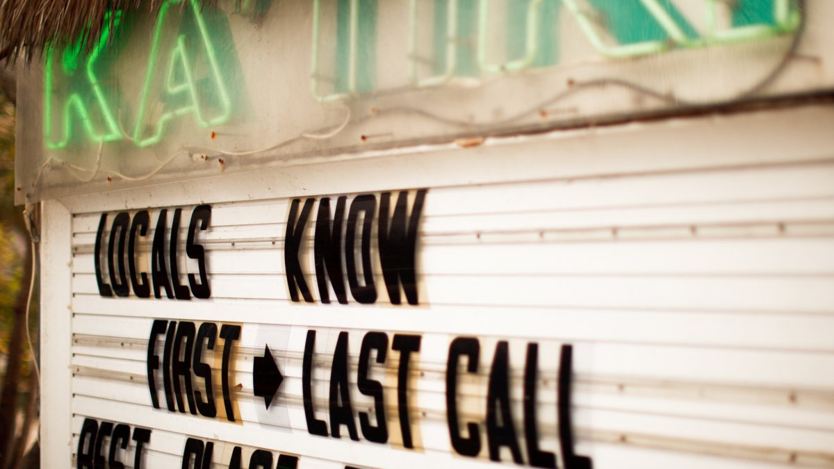 Restaurant sign for Ka'Tiki that says Locals Know First and Last Call and Best Place to Drink