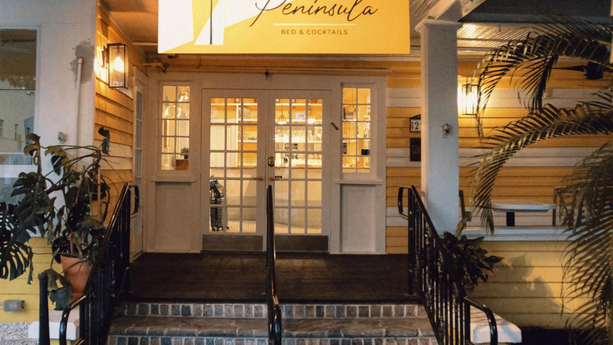 front facade and brick steps leading to French doors at Peninsula Bed & Cocktails