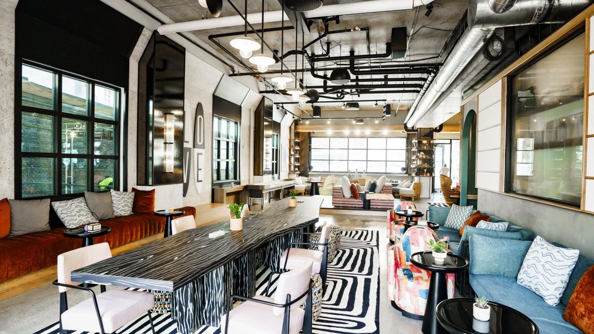 bold and modern decor and industrial accents in a hotel lobby with a black and white striped carpet