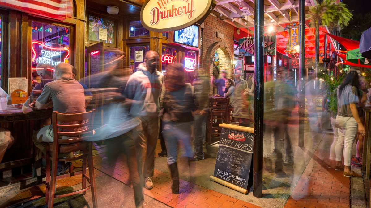 Outdoor tables and customers at Five Buck's Drinkery
