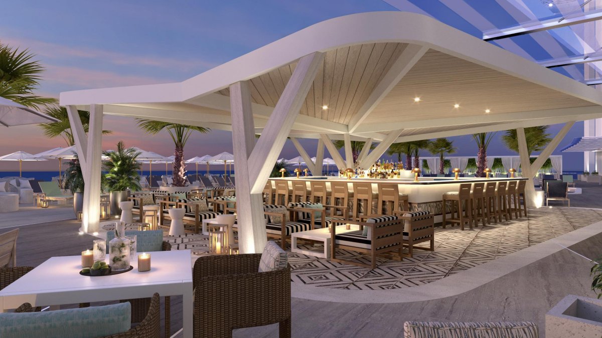 an elegant beach and pool bar at dusk