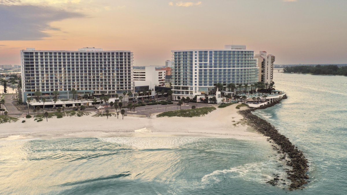 a view of two large beachfront resorts in Clearwater Beach, Opal Sol and Opal Sands, with a jetty in front