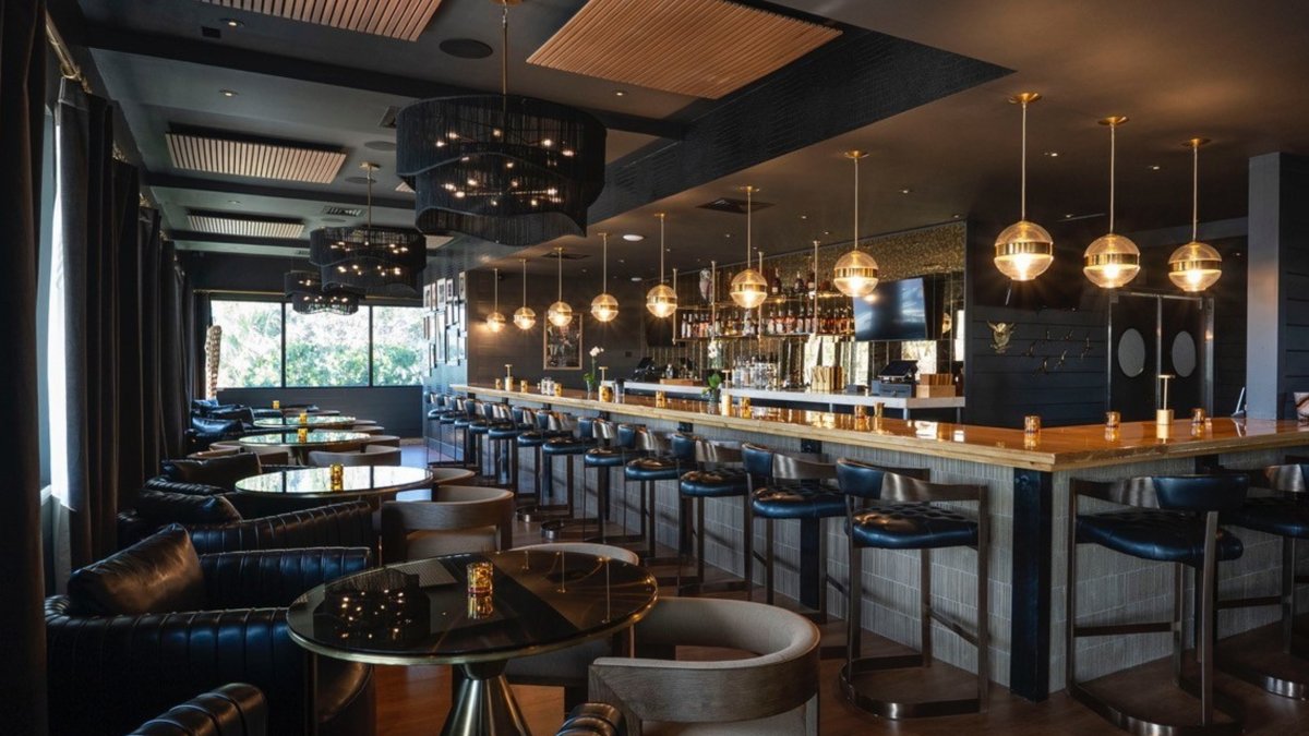 a traditional and elegant bar and tables at Malio's Beach House restaurant